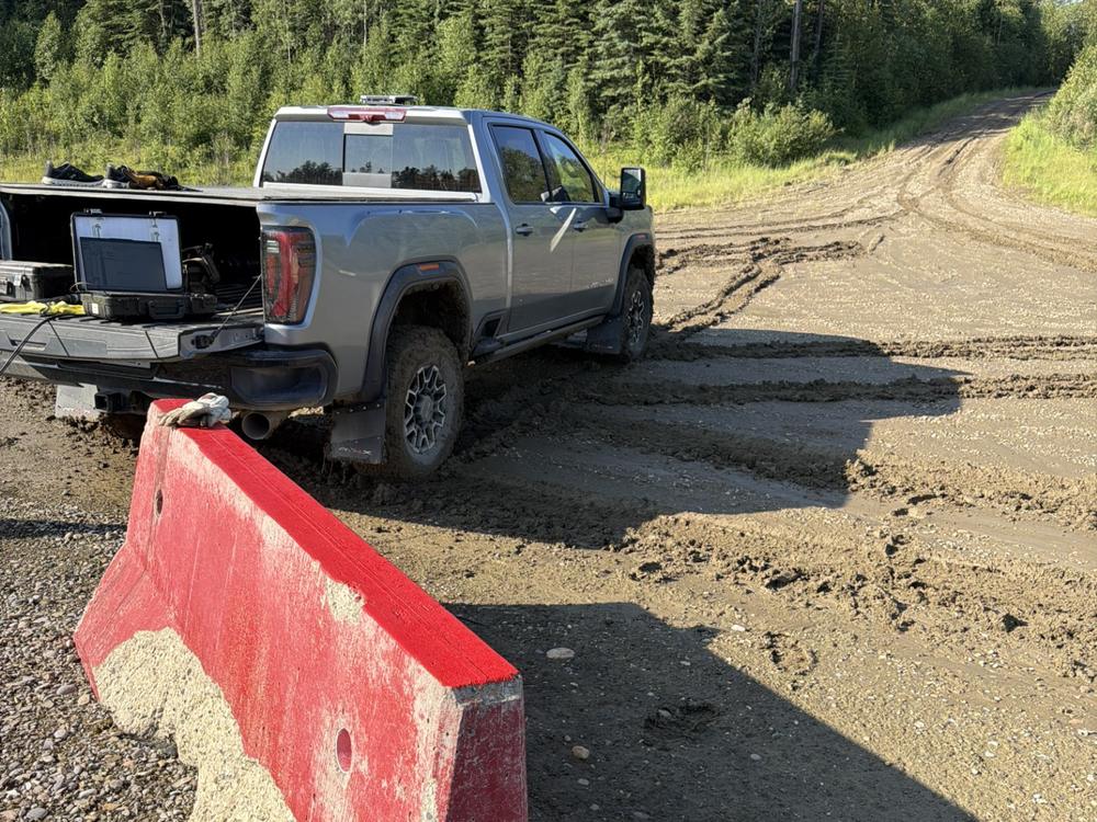 LynxLift truck on a lease road with Echometer acoustic equipment set up on the tailgate